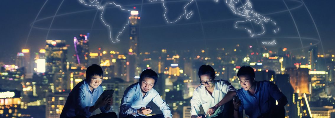 Business group in casual suits using smartphone, tablet and laptop