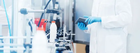 Worker inspecting production line