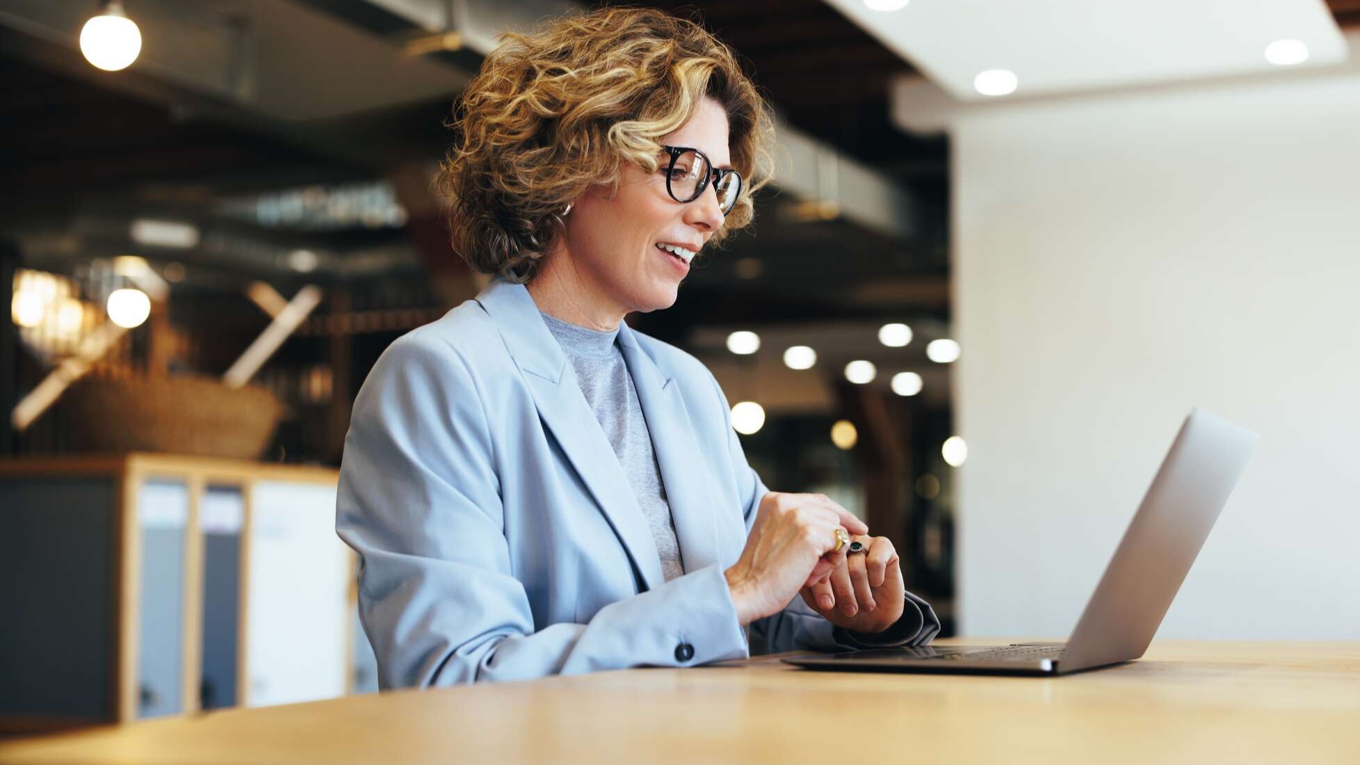 Professional woman having an online meeting on a laptop in an office