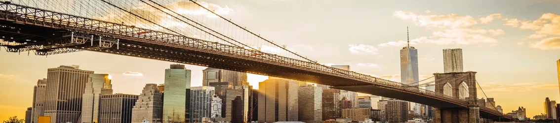 The setting sun shines behind a cityscape in this Banner image for Certification Resource Center 