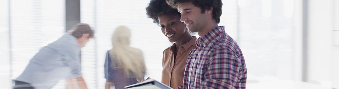 Customer satisfaction management-happy customers looking at tablet