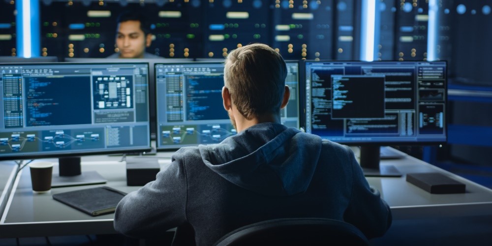 man looking at a digital screen on the wall