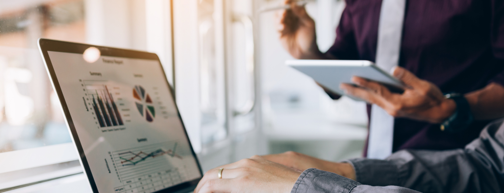 Two people working together in computers for an audit